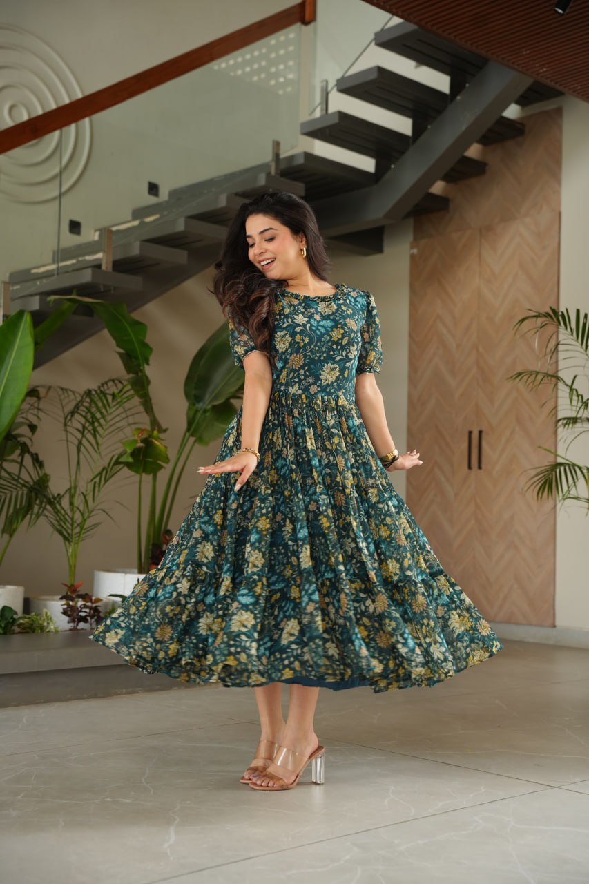 Vikarni Green Printed Anarkali Gown in faux georgette with 12-meter flair – perfect ethnic wear for women, long gown for women, printed gown for girls, Anarkali gown for wedding, georgette gown for festive wear, Indian dress for women, traditional wear for haldi ceremony, party wear gown online, readymade gown under 1000, stylish green ethnic gown for mehndi function.